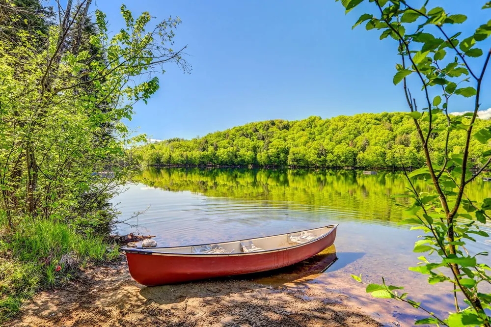 Red canoe on the shore of Lac Moore