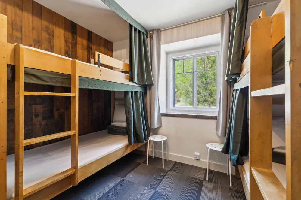 Shared dorm with wooden bunks