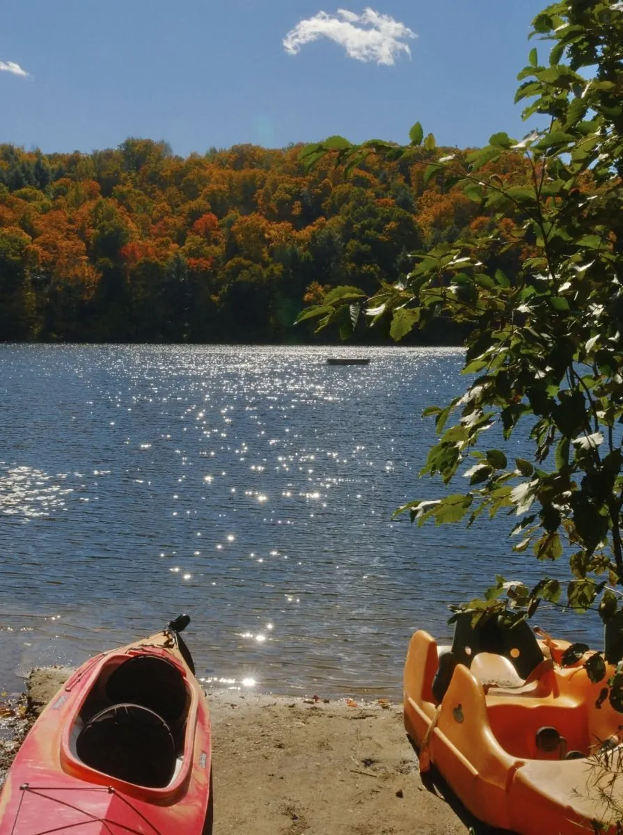 Lac Moore in fall colours with kayaks on the beach