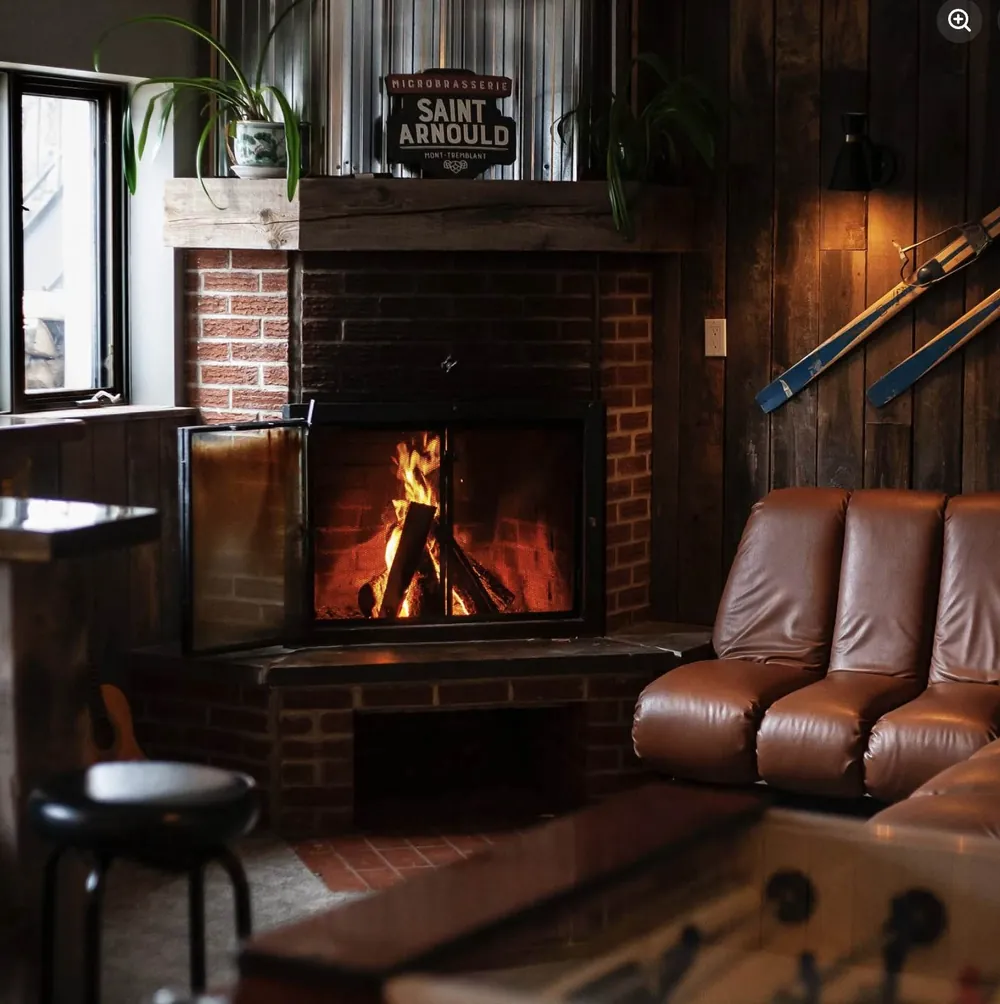 The lounge with brick fireplace and leather couch