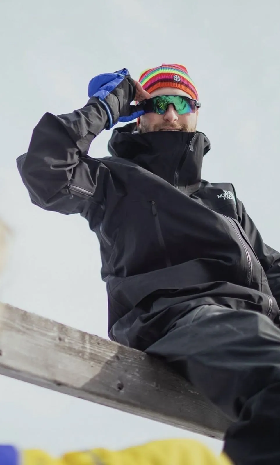 Mathieu skiing in a rainbow toque and goggles
